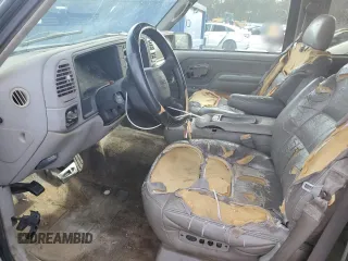 1999 GMC Yukon with VIN 1GKEC13R7XJ802387, listed as a Copart auction lot 82819934 with 438,574 mi miles and Salvage Title. Bid and sale history available at carsss.com. Image 7.