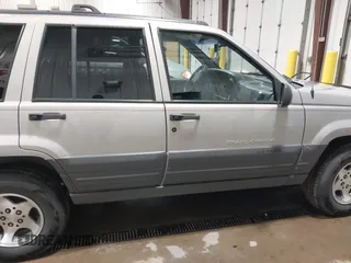 1996 Jeep Grand Cherokee Laredo z VIN 1J4GZ58S5TC293897, wystawiony jako IAAI lot #42435233 z przebiegiem 167 432 mil mil oraz . Historia ofert i sprzedaży dostępna na DreamBid. Obrazek 13.