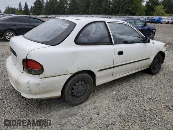 1999 Hyundai Accent with VIN KMHVD14N9XU503210, listed as a Copart auction lot 56486325 with 195,501 mi miles and Salvage title. Bid and sale history available at DreamBid. Image 3.