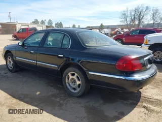 1999 Lincoln Continental with VIN 1LNHM97V8XY686521, listed as a IAAI auction lot 41681027 with 144,407 mi miles. Bid and sale history available at carsss.com. Image 3.