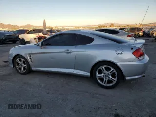 2005 Hyundai Tiburon GT z VIN KMHHN65F05U171038, wystawiony jako Copart lot #87765735 z przebiegiem 113 129 mil mil oraz Szkody całkowita. Historia ofert i sprzedaży dostępna na DreamBid. Obrazek 2.