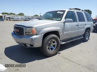 1999 GMC Denali z VIN 1GKEK13R6XR914411, wystawiony jako Copart lot #56063555 z przebiegiem 231 344 mil mil oraz Szkody całkowita. Historia ofert i sprzedaży dostępna na DreamBid. Obrazek 1.