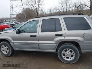 1999 Jeep Grand Cherokee Laredo with VIN 1J4GW58N0XC748809, listed as a IAAI auction lot 41722910 with 201,407 mi miles. Bid and sale history available at carsss.com. Image 14.