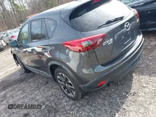 2016 Mazda CX-5 Grand Touring z VIN JM3KE4DY5G0836891, wystawiony jako IAAI lot #41441065 z przebiegiem 120 808 mil mil oraz . Historia ofert i sprzedaży dostępna na DreamBid. Obrazek 3.