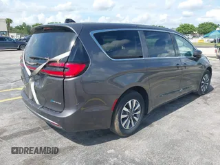 2023 Chrysler Pacifica Hybrid Touring L with VIN 2C4RC1L74PR579782, listed as a IAAI auction lot 42487390 with Not provided miles and . Bid and sale history available at DreamBid. Image 4.