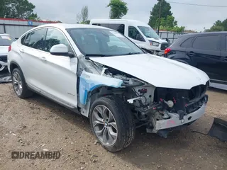 2015 BMW X4 xDrive28i with VIN 5UXXW3C51F0M86668, listed as a IAAI auction lot 42489071 with 59,694 mi miles and . Bid and sale history available at DreamBid. Image 1.