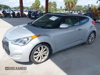 2012 Hyundai Veloster w/Gray Int z VIN KMHTC6ADXCU056898, wystawiony jako IAAI lot #40366687 z przebiegiem 137 161 mil mil oraz . Historia ofert i sprzedaży dostępna na DreamBid. Obrazek 2.