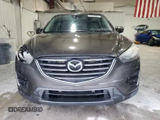 2016 Mazda CX-5 Grand Touring z VIN JM3KE2DY5G0821683, wystawiony jako Copart lot #51929905 z przebiegiem 119 392 mil mil oraz Czysty tytuł • Clean title. Historia ofert i sprzedaży dostępna na DreamBid. Obrazek 5.