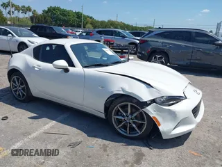 2021 Mazda MX-5 Miata Grand Touring z VIN JM1NDAM75M0450871, wystawiony jako IAAI lot #42060495 z przebiegiem 48 670 mil mil oraz . Historia ofert i sprzedaży dostępna na DreamBid. Obrazek 1.