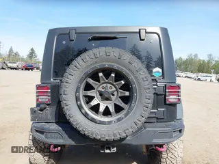 2015 Jeep Wrangler Unlimited Willys Wheeler with VIN 1C4BJWDG9FL750049, listed as a IAAI auction lot 42136188 with 115,328 mi miles and . Bid and sale history available at DreamBid. Image 17.