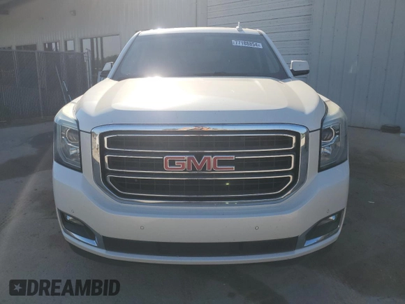 2015 GMC Yukon SLT with VIN 1GKS1BKCXFR563509, listed as a Copart auction lot 77188854 with 127,481 mi miles and Clean Title. Bid and sale history available at carsss.com. Image 5.