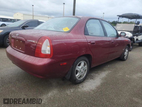 1999 Daewoo Nubira CDX z VIN KLAJB52Z5XK256700, wystawiony jako Copart lot #75085934 z przebiegiem Nie podano mil oraz Szkody całkowita. Historia ofert i sprzedaży dostępna na DreamBid. Obrazek 3.