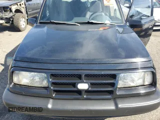 1998 Chevrolet Tracker z VIN 2CNBJ1868W6925819, wystawiony jako Copart lot #70881874 z przebiegiem 180 849 mil mil oraz Szkoda całkowita • Salvage title. Historia ofert i sprzedaży dostępna na DreamBid. Obrazek 12.