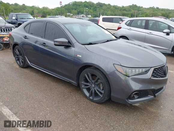 2019 Acura TLX w/A-Spec Pkg z VIN 19UUB2F61KA000932, wystawiony jako IAAI lot #42164064 z przebiegiem 79 080 mil mil oraz . Historia ofert i sprzedaży dostępna na DreamBid. Obrazek 1.