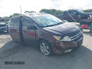 2011 Honda Odyssey Touring with VIN 5FNRL5H97BB008759, listed as a IAAI auction lot 41567010 with 215,709 mi miles and . Bid and sale history available at DreamBid. Image 1.