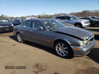 2004 Jaguar XJ with VIN SAJWA71C74SG34056, listed as a Copart auction lot 80083014 with 0 mi miles and Salvage Title. Bid and sale history available at carsss.com. Image 4.