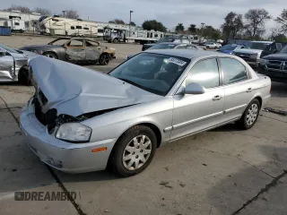 2006 Kia Optima LX z VIN KNAGD126565468244, wystawiony jako Copart lot #85373304 z przebiegiem 118 397 mil mil oraz Szkoda całkowita • Salvage title. Historia ofert i sprzedaży dostępna na DreamBid. Obrazek 1.