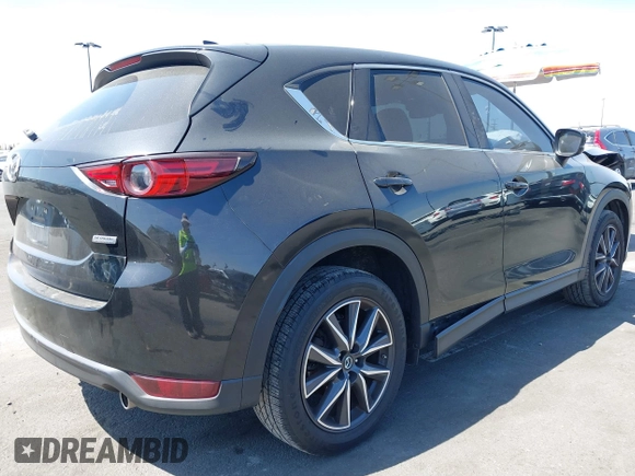 2018 Mazda CX-5 Grand Touring z VIN JM3KFADM7J0327272, wystawiony jako IAAI lot #42279536 z przebiegiem 97 478 mil mil oraz . Historia ofert i sprzedaży dostępna na DreamBid. Obrazek 4.