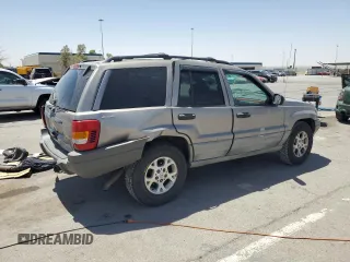 1999 Jeep Grand Cherokee Laredo with VIN 1J4GW58S1XC775877, listed as a Copart auction lot 55639795 with 197,611 mi miles and Salvage title. Bid and sale history available at DreamBid. Image 3.