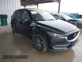 2021 Mazda CX-5 Signature with VIN JM3KFBEY5M0432033, listed as a IAAI auction lot 41607215 with 49,870 mi miles. Bid and sale history available at carsss.com. Image 1.