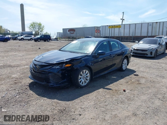 2019 Toyota Camry LE with VIN 4T1B11HK6KU276644, listed as a IAAI auction lot 42037249 with 23,677 mi miles and . Bid and sale history available at DreamBid. Image 2.