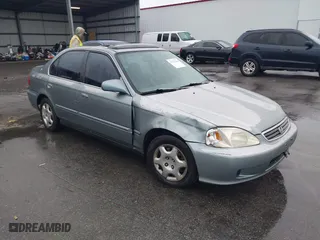 1999 Honda Civic EX with VIN 1HGEJ8643XL010821, listed as a IAAI auction lot 41602036 with 165,139 mi miles. Bid and sale history available at carsss.com. Image 1.