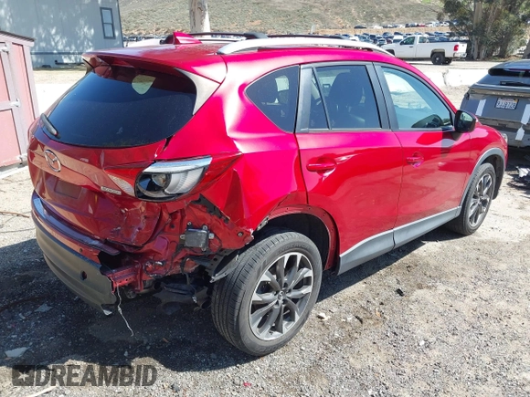 2016 Mazda CX-5 Grand Touring with VIN JM3KE2DY3G0686588, listed as a IAAI auction lot 41697312 with 65,090 mi miles. Bid and sale history available at carsss.com. Image 4.