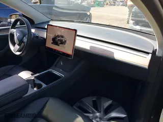 2023 Tesla Model Y Long Range with VIN 7SAYGDEEXPA175104, listed as a IAAI auction lot 41821928 with 52,791 mi miles. Bid and sale history available at carsss.com. Image 5.