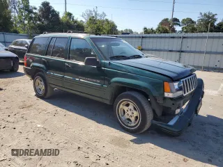 1998 Jeep Grand Cherokee with VIN 1J4FX48S8WC281615, listed as a Copart auction lot 77305594 with 128,393 mi miles and Salvage title. Bid and sale history available at DreamBid. Image 4.