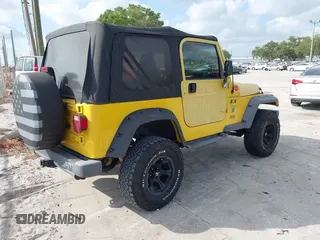 2002 Jeep Wrangler X z VIN 1J4FA39S82P719241, wystawiony jako IAAI lot #42150742 z przebiegiem 147 914 mil mil oraz . Historia ofert i sprzedaży dostępna na DreamBid. Obrazek 4.