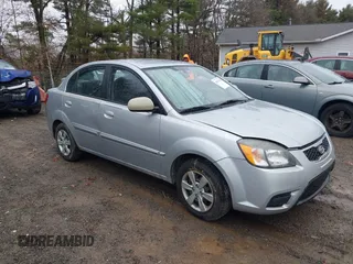 2010 Kia Rio LX with VIN KNADH4A37A6645279, listed as a IAAI auction lot 40856780 with 165,385 mi miles. Bid and sale history available at carsss.com. Image 1.
