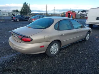 1999 Ford Taurus SE with VIN 1FAFP53U0XG209151, listed as a IAAI auction lot 41778371 with 107,262 mi miles. Bid and sale history available at carsss.com. Image 4.