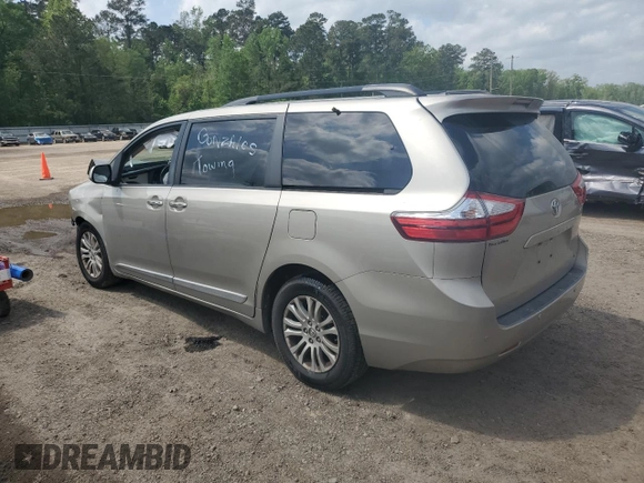 2016 Toyota Sienna XLE with VIN 5TDYK3DC0GS697468, listed as a Copart auction lot 51186795 with 128,851 mi miles and Salvage Title. Bid and sale history available at DreamBid. Image 2.