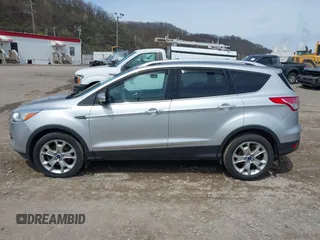 2016 Ford Escape Titanium with VIN 1FMCU9JX3GUA62802, listed as a IAAI auction lot 42001690 with 124,452 mi miles. Bid and sale history available at carsss.com. Image 14.
