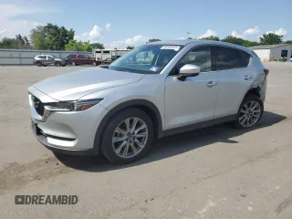 2019 Mazda CX-5 Grand Touring z VIN JM3KFADM2K1542151, wystawiony jako Copart lot #63262455 z przebiegiem 48 285 mil mil oraz Szkoda całkowita • Salvage title. Historia ofert i sprzedaży dostępna na DreamBid. Obrazek 1.