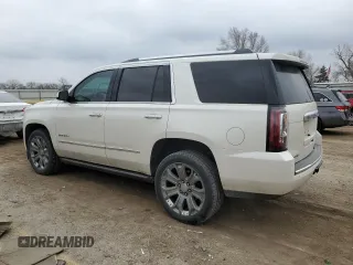 2015 GMC Yukon Denali with VIN 1GKS1CKJ1FR619793, listed as a Copart auction lot 86910314 with 128,559 mi miles and Salvage Title. Bid and sale history available at carsss.com. Image 2.