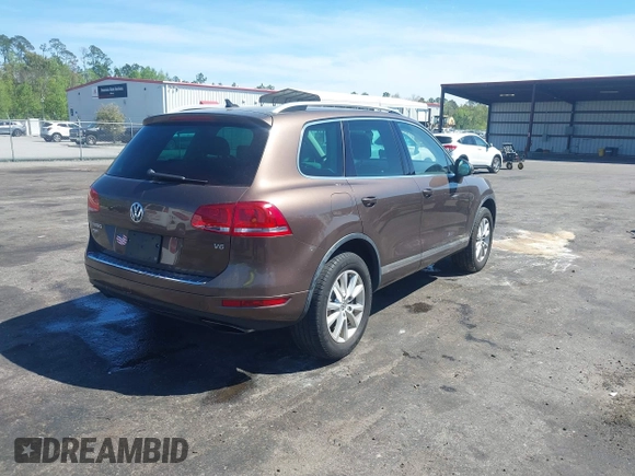 2014 Volkswagen Touareg Sport with VIN WVGEF9BP7ED003525, listed as a IAAI auction lot 41868307 with 74,379 mi miles and . Bid and sale history available at DreamBid. Image 4.