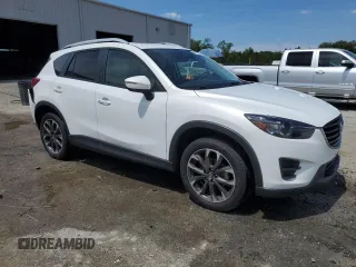2016 Mazda CX-5 Grand Touring z VIN JM3KE2DYXG0731462, wystawiony jako Copart lot #58220465 z przebiegiem 130 033 mil mil oraz Szkoda całkowita • Salvage title. Historia ofert i sprzedaży dostępna na DreamBid. Obrazek 4.