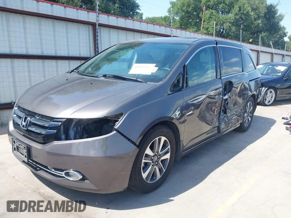2014 Honda Odyssey Touring with VIN 5FNRL5H99EB075979, listed as a IAAI auction lot 42520154 with 99,314 mi miles and . Bid and sale history available at DreamBid. Image 2.