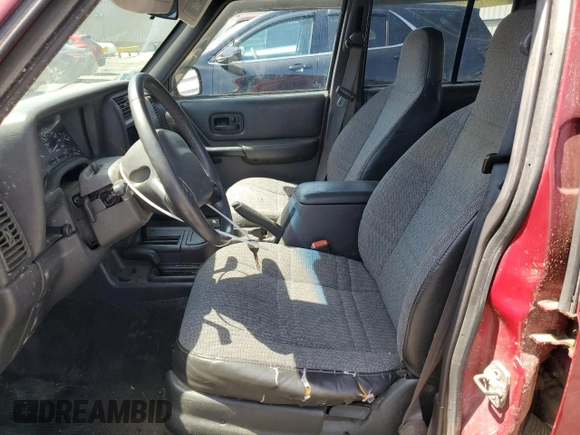 1999 Jeep Cherokee Sport z VIN 1J4FF68S7XL590900, wystawiony jako Copart lot #55098635 z przebiegiem 265 588 mil mil oraz Szkoda całkowita • Salvage title. Historia ofert i sprzedaży dostępna na DreamBid. Obrazek 7.