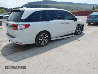 2021 Honda Odyssey Touring with VIN 5FNRL6H80MB010952, listed as a IAAI auction lot 42080412 with 90,594 mi miles and . Bid and sale history available at DreamBid. Image 4.