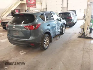 2016 Mazda CX-5 Touring z VIN JM3KE4CY2G0839202, wystawiony jako IAAI lot #41901207 z przebiegiem 65 449 mil mil oraz . Historia ofert i sprzedaży dostępna na DreamBid. Obrazek 4.