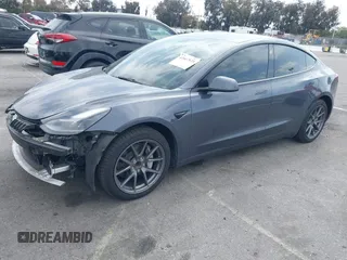 2023 Tesla Model 3 with VIN 5YJ3E1EA4PF410060, listed as a IAAI auction lot 42067624 with 59,934 mi miles and . Bid and sale history available at DreamBid. Image 2.