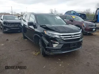 2017 Honda Pilot Touring with VIN 5FNYF6H95HB007854, listed as a IAAI auction lot 41955509 with 103,202 mi miles. Bid and sale history available at carsss.com. Image 1.
