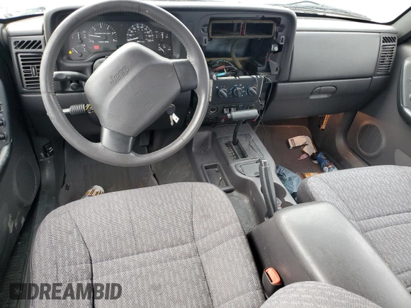 1999 Jeep Cherokee Sport with VIN 1J4FT68S1XL577603, listed as a Copart auction lot 54216115 with 180,128 mi miles and Salvage title. Bid and sale history available at DreamBid. Image 8.