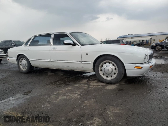 1999 Jaguar XJ with VIN SAJKD6041XC876928, listed as a Copart auction lot 60038405 with 63,917 mi miles and Clean title. Bid and sale history available at DreamBid. Image 4.