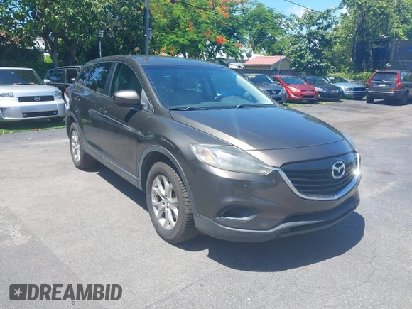 2015 Mazda CX-9 Touring z VIN JM3TB2CV1F0458995, wystawiony jako IAAI lot #42523344 z przebiegiem 130 763 mil mil oraz . Historia ofert i sprzedaży dostępna na DreamBid. Obrazek 1.