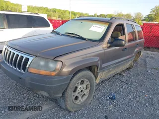 2002 Jeep Grand Cherokee with VIN 1J4GW38N42C202219, listed as a IAAI auction lot 42035162 with 220,012 mi miles and . Bid and sale history available at DreamBid. Image 2.