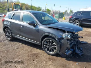 2016 Mazda CX-5 Grand Touring z VIN JM3KE4DY3G0796049, wystawiony jako IAAI lot #42198347 z przebiegiem 100 423 mil mil oraz . Historia ofert i sprzedaży dostępna na DreamBid. Obrazek 1.