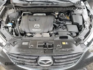2016 Mazda CX-5 Grand Touring z VIN JM3KE2DY9G0687261, wystawiony jako Copart lot #52865415 z przebiegiem Nie podano mil oraz Szkoda całkowita • Salvage title. Historia ofert i sprzedaży dostępna na DreamBid. Obrazek 13.